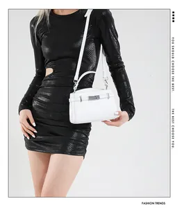 Detail of white lychee grain leather handbag with silver lock and detachable shoulder strap