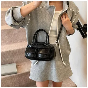 Detailed view of black retro underarm bag with double front flap pockets and straps
