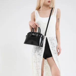 Fashionable black glossy shell bag with silver buckle and detachable shoulder strap
