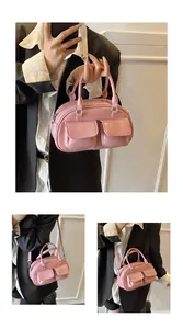 Close-up of pink glossy bowling bag showing multi-pockets and shiny faux leather texture