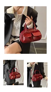 Detail view of glossy red retro pillow bag with functional front flap pockets