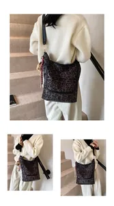 Detailed macro view of large leopard print tote bag with plush doll and tassel charm