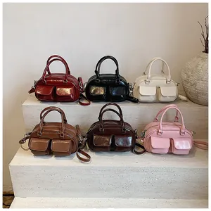 Close-up of vintage mini Boston bags in six colors with glossy patent leather finish