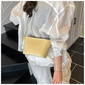 Macro detail of the woven texture and light yellow leather on the bucket shoulder bag