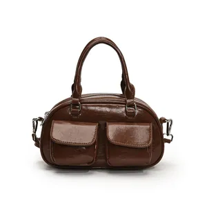 Vintage dark brown glossy underarm bag with double front pockets and twin handles