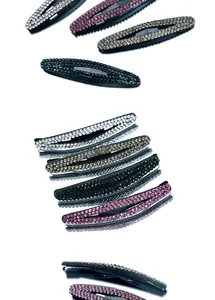 Detailed view of four teardrop rhinestone snap hair clips in silver, pink, gold, and green