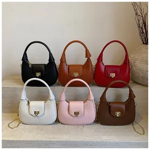 Detail shot of woven texture semi-circle handbags with elegant gold chain and metal lock