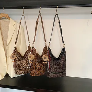 Large leopard print tote bag with adjustable strap and plush sheep charm for daily commute