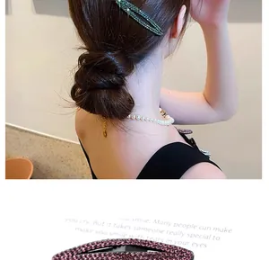 Macro view of oval hair clips with sparkling rhinestones in dark green and pink