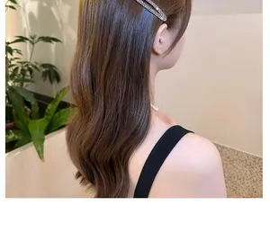 Sparkling silver rhinestone oval hair clip side styling on brown wavy hair
