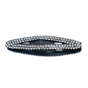 Elegant sparkling oval hair clip with three rows of clear crystals on a black base