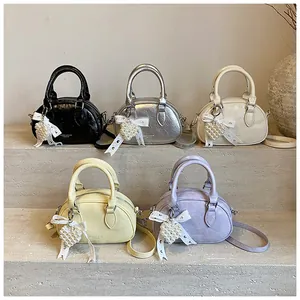 Detail view of stylish bowling bags in five colors with pearl heart and lace bow