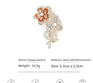 Close-up of golden crystal flower brooch with champagne rhinestones and leaf details