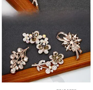 Detailed close-up of crystal butterfly brooch with rose gold finish on velvet background