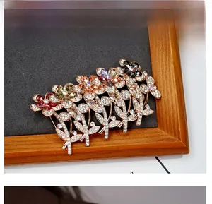 Close-up of rose gold crystal floral brooches with colorful rhinestones in 5-piece set