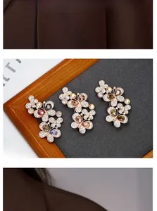 Detailed view of three vintage crystal butterfly brooches in rose gold setting