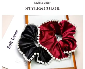 Detail view of black and wine red velvet scrunchies with elegant pearl bead trim