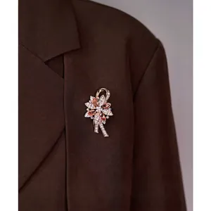 Elegant crystal flower brooch with champagne gems on a dark suit lapel for women