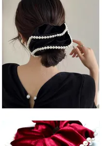 Detail of elegant velvet hair scrunchie with pearl trim edges for women hair styling