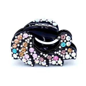Elegant black acrylic hair claw clip with multi-color rhinestones in a wave design