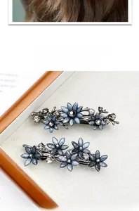 Detailansicht der Retro-Blumen-Haarspangen mit blauen Blütenblättern und Kristallen