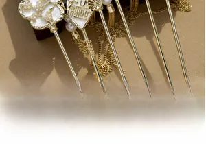 Detailed macro of golden Chinese hairpins with fans, plum blossoms and tassels