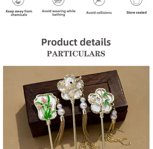 Detail of three vintage Chinese gold hairpins with enamel floral patterns and silk tassels