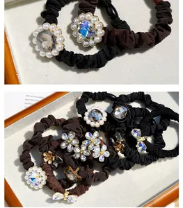 Detail of luxury hair ties with crystals, pearls and bows in black and dark brown