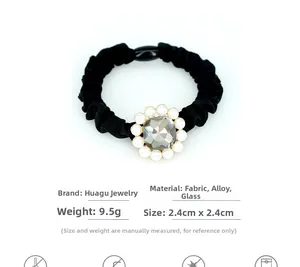 Macro detail of elastic hair scrunchie with crystal flower and pearl centerpiece