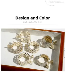 Detail view of 6 gold metal hair claw clips with rhinestones in a display tray