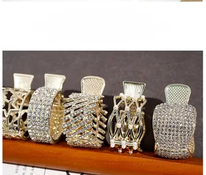 Set of five gold alloy hair claw clips with rhinestones and faux pearls for high ponytails