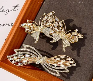 Detail of luxury gold butterfly hair clips with handset rhinestones and crystals