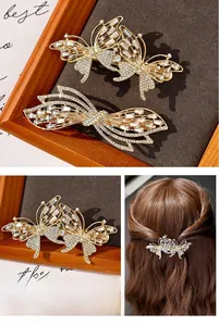 Detail of golden butterfly hair clips with sparkling rhinestones on dark textured background