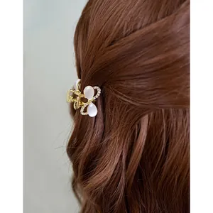 Eleganter Haarclip aus Goldmetall mit Katzenaugen-Steinen und Strass für Damen