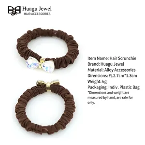 Elegant set of brown ruffled fabric hair scrunchies with crystal heart bow accents
