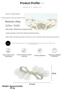 Detail view of 9.3x4cm golden alloy butterfly hair clip with white rhinestones and pearls