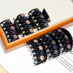Elegant acrylic hair claws with colorful rhinestone flowers and black glossy finish