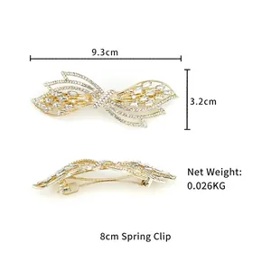 Elegant gold butterfly hair clip with sparkling rhinestones and crystals on white background