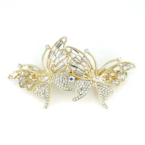 Elegant gold butterfly hair clip with shimmering rhinestones and blue crystal detail
