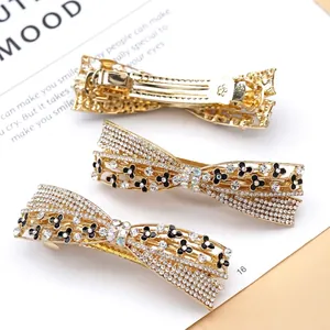 Sparkling rhinestone bow hair clip with black floral pattern and gold alloy spring clip