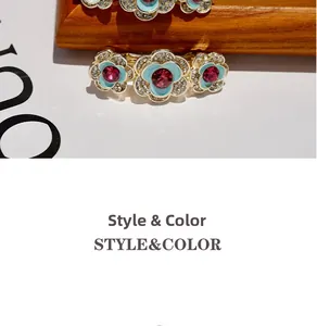 Detailed macro view of blue enamel flower hair clip with diamonds and gold plating