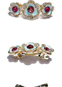 Detail of rose hair clip with blue enamel, pink gemstone and sparkling crystals
