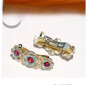 Detail of blue alloy flower hairpins with red rhinestones and spring clip back