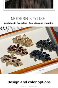 Detailed set of crystal flower hair clips in five colors on a wooden jewelry display tray