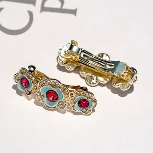 Vintage camellia hair clips with blue enamel, red crystals and gold spring clips