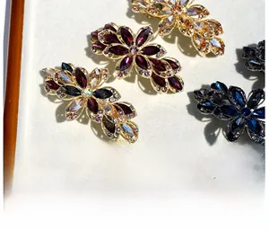 Macro detail of elegant flower hair clips with colorful rhinestones on rose gold base