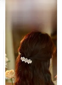 Detailed view of luxury flower zircon hair clip with pearls on a half-up hairstyle