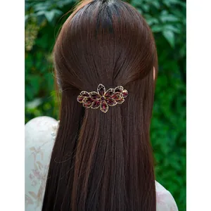 Elegant flower hair clip with deep purple crystals on gold metal for women