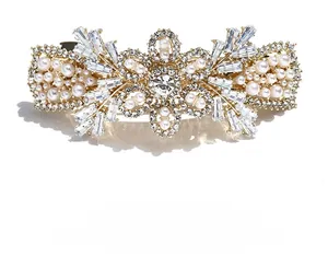Macro shot of rose gold luxury hair clip with white crystals and elegant pearls