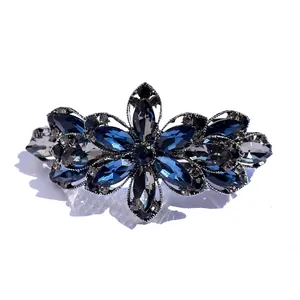 Elegant floral hair clip with blue crystals and vintage alloy base on white background